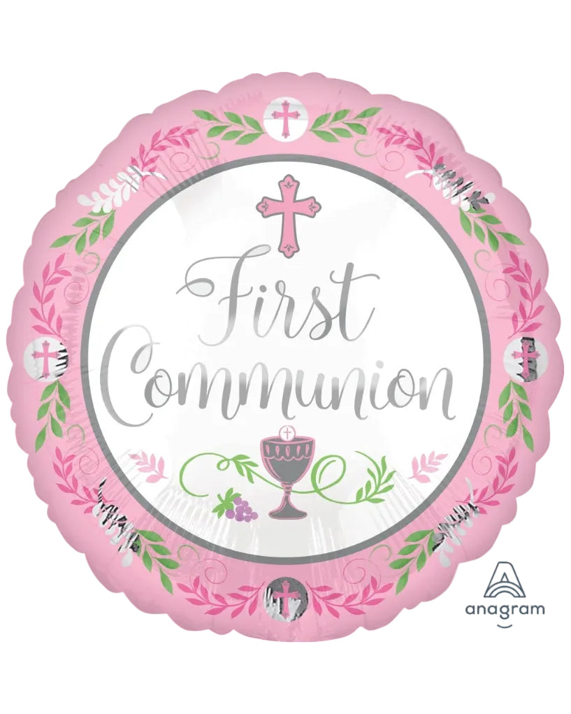Pink 'First Communion' balloon with religious symbols on a white background