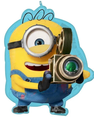 A Minions character-shaped foil balloon featuring a yellow goblin with blue overalls, one large eye, and a vintage camera, shown on a plain white background.