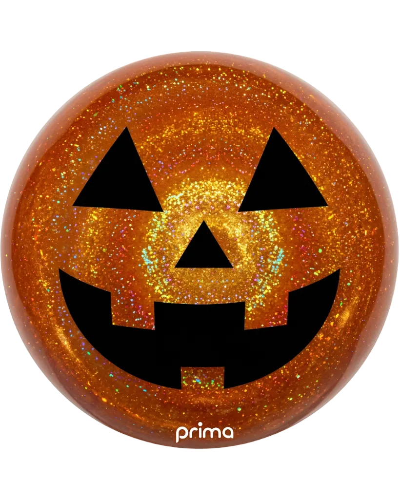 An orange pumpkin jackie coaster with a glittery finish and a black jack-o'-lantern face, featuring the 'prima' brand logo at the bottom.