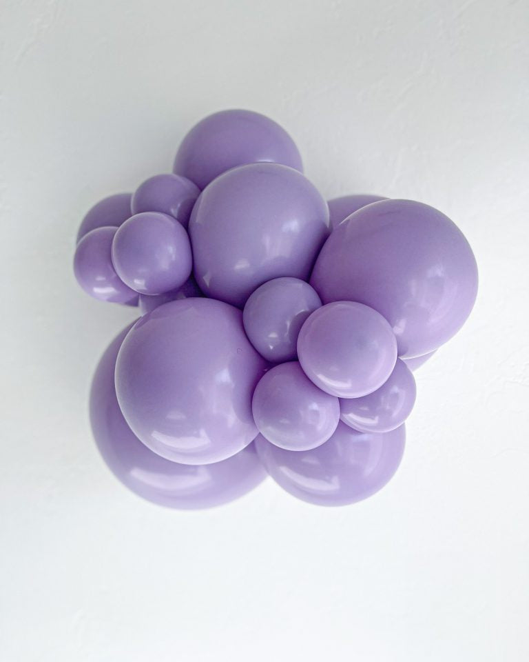 Cluster of purple balloons on a white background