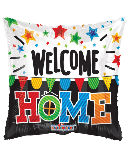 A square foil balloon pillow with a festive 'Welcome Home' design. The top half is white with colorful star confetti and the word 'WELCOME' in black.
