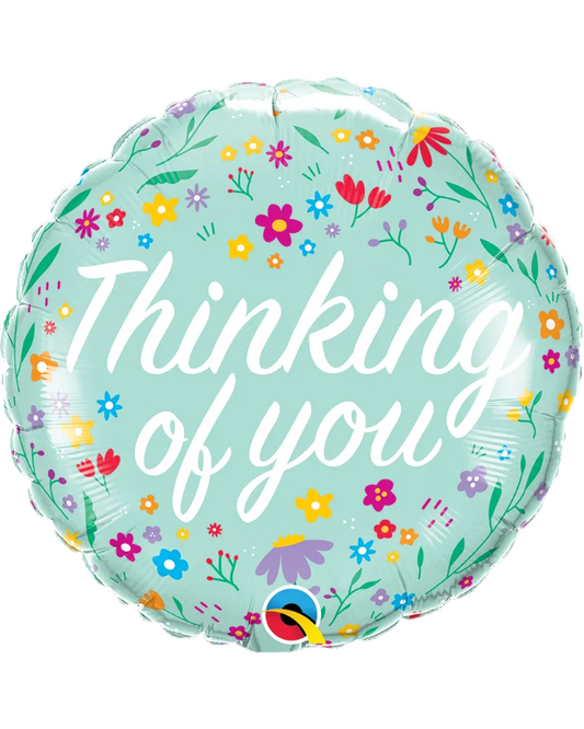 Round balloon with floral design and 'Thinking of you' text on a light blue background