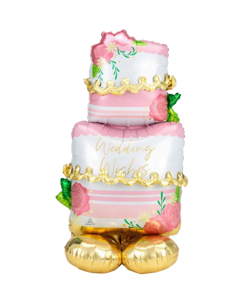 A 3-tiered cake-shaped foil balloon set with pink and white layers, gold trim, floral details, and gold 'Wedding Wishes' lettering, shown on a plain white background.