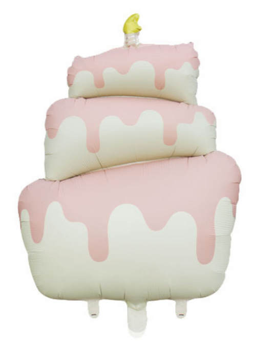Pink and white cake-shaped pillow with a small yellow candle on a white background