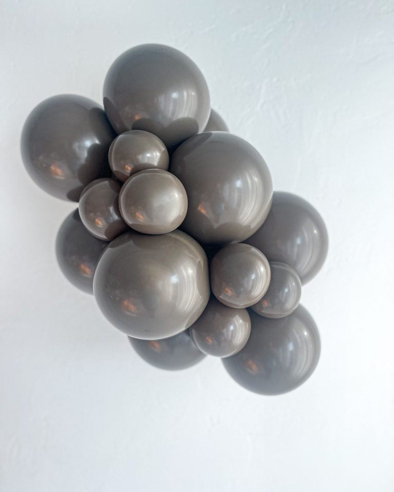 Cluster of gray balloons on a white background