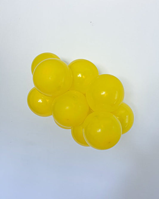 Cluster of yellow balls on a white background