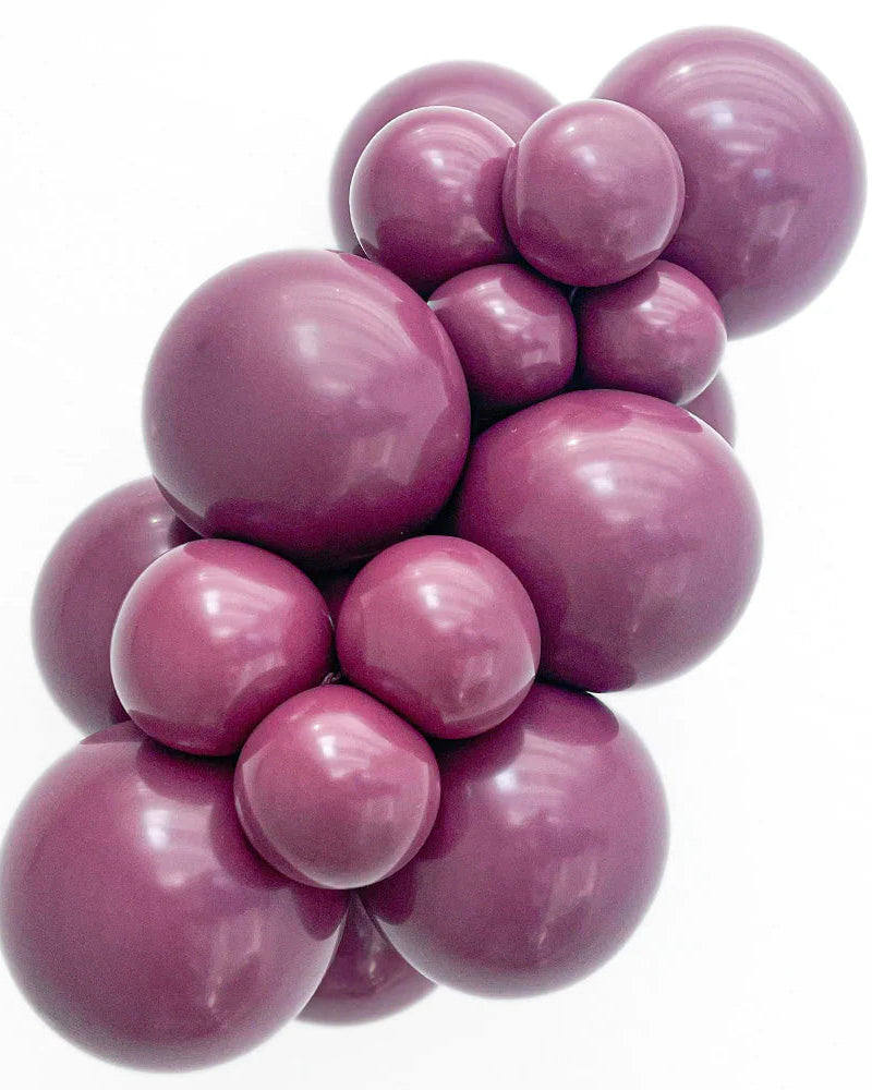 Cluster of purple balloons on a white background