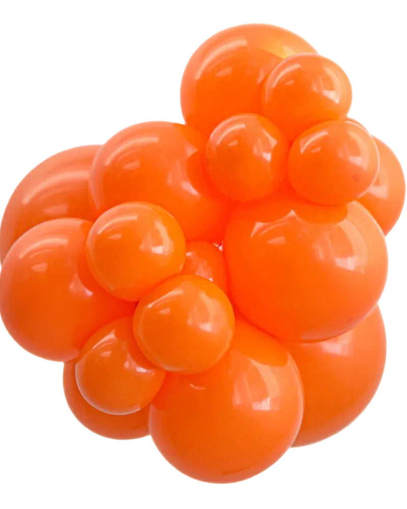Cluster of orange balloons on a white background