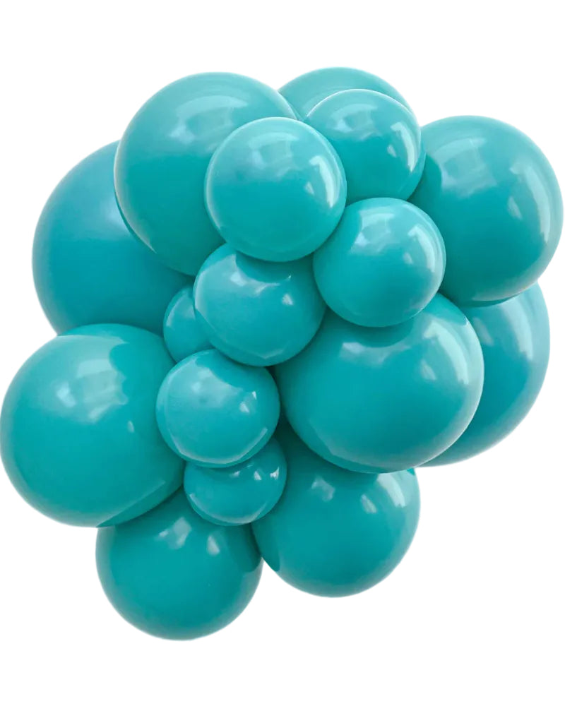 Turquoise ball pit balls on a white background