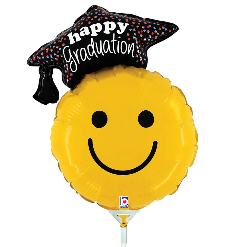 Graduation-themed balloon with smiley face and 'happy graduation' cap on a white background