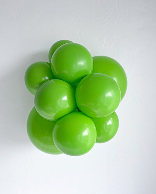 Cluster of lime green balloons on a white background
