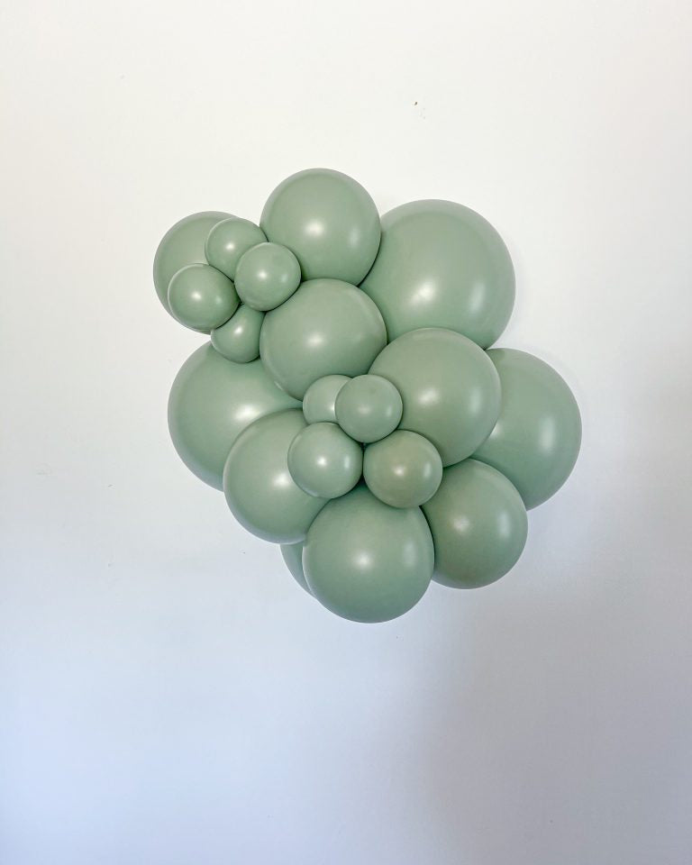 Cluster of green balloons against a light gradient background